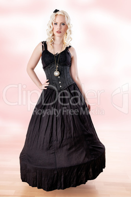 Woman with curly hair in long black dress