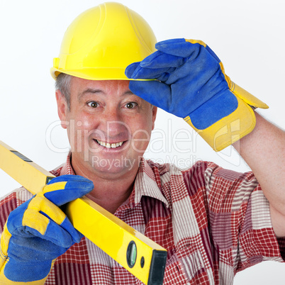 Friendly construction worker with a spirit level and safety gloves