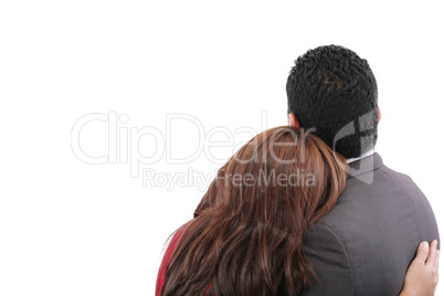 Rear view of a loving couple standing with arms around