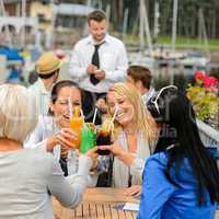 Women celebrating with cocktails at restaurant