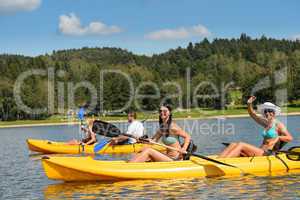 Young people sunbathing on kayak