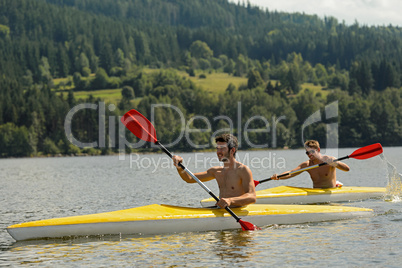 Kayaking sporty men on river sunshine
