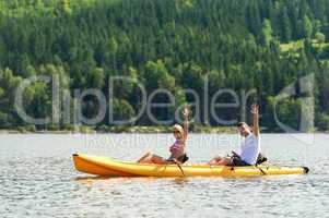 Man and woman kayaking on pond vacation