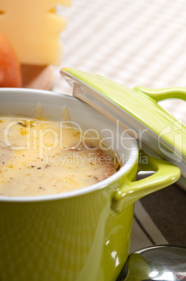 oinion soup with melted cheese and bread on top