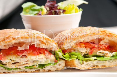 ciabatta panini sandwich with chicken and tomato