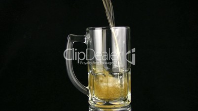 The beer is poured in a mug. Black background