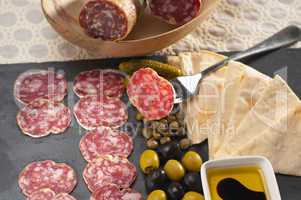 cold cut platter with pita bread and pickles