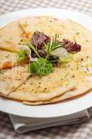 garlic pita bread pizza with salad on top