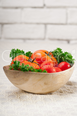 tomatoes on a wood bowl