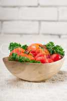 tomatoes on a wood bowl