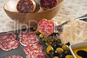 cold cut platter with pita bread and pickles