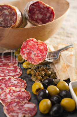 cold cut platter with pita bread and pickles