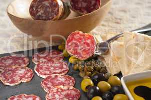 cold cut platter with pita bread and pickles