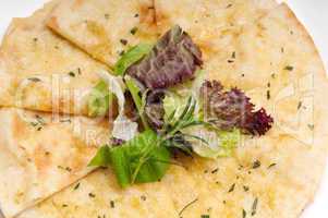 garlic pita bread pizza with salad on top