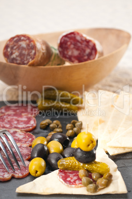 cold cut platter with pita bread and pickles