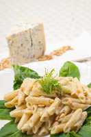 Italian pasta penne gorgonzola and pine nuts