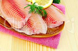 Fillets tilapia in a pottery on a napkin