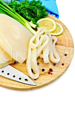 Squid with lemon and knife on a round board