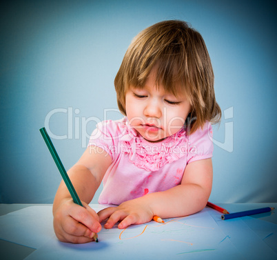 Little baby girl draws pencil