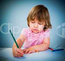 Little baby girl draws pencil