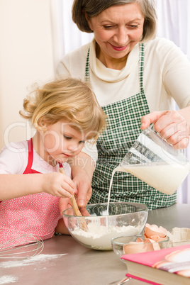 Grandmother and granddaughter baking cookies