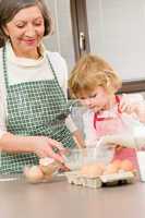 Grandmother and granddaughter prepare dough