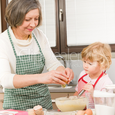 Grandmother and granddaughter baking cookies