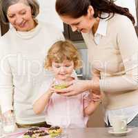 Women generations around cupcake cookies