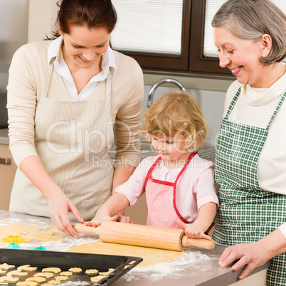 3 generations women rolling dough for baking