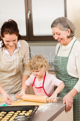 3 generations women rolling dough for baking