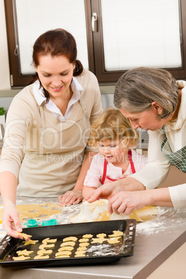 3 generations women prepare dough for baking