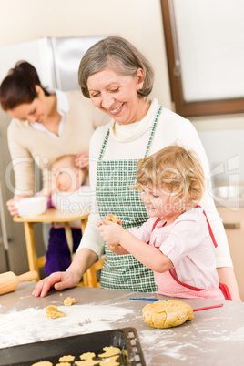 Grandmother with little girl prepare dough