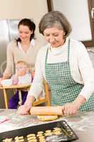 Grandmother rolling dough for cookies