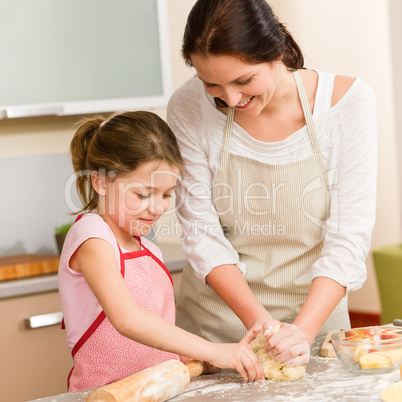 Mother and daughter prepare dough home cake