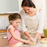 Mother and daughter prepare dough home cake