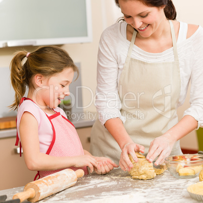 Mother and daughter prepare dough home cake