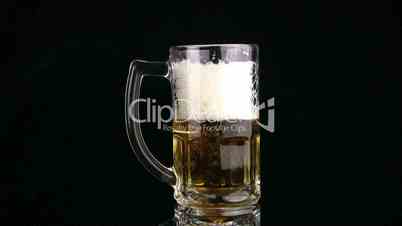 The beer is poured fast through edge of mug