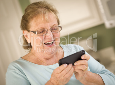 Senior Adult Woman Texting on Smart Cell Phone