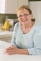 Portrait of Beautiful Senior Adult Woman in Kitchen