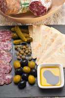 cold cut platter with pita bread and pickles