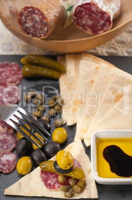 cold cut platter with pita bread and pickles