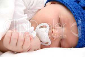 sleeping baby with pacifier closeup