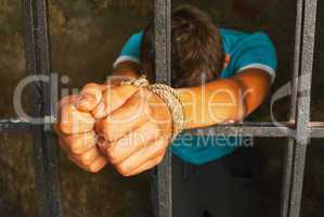 Man with hands tied up with rope