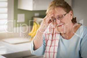Sad Crying Senior Adult Woman At Kitchen Sink