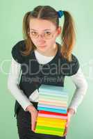 Teen girl with a stack of books