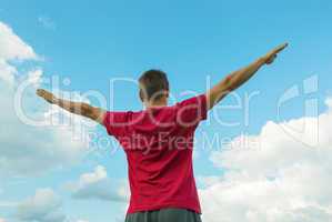 Young man staying with raised hands