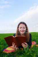 teen girl reading the bible outdoors