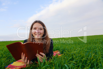 teen girl reading the bible outdoors