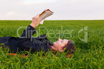 teen girl reading the bible outdoors