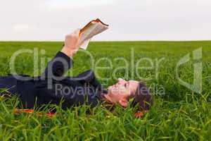 teen girl reading the bible outdoors